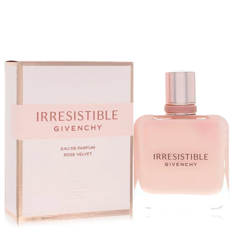 Irresistible Givenchy Rose Velvet Perfume signature luxury weighted clear glass flacon finished in a soft powdered pink sensory coating, displaying precise white typographical branding details and an elegant metallic capping architecture detail against a solid backdrop