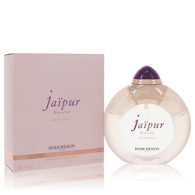 Boucheron Jaipur Bracelet Eau de Parfum signature luxury clear architectural glass column jewelry flacon showcasing its transparent fluid boundaries, styled with elegant brand markings layout, and topped with an ornate sculpted pink gemstone capping accent design detail against a solid backdrop