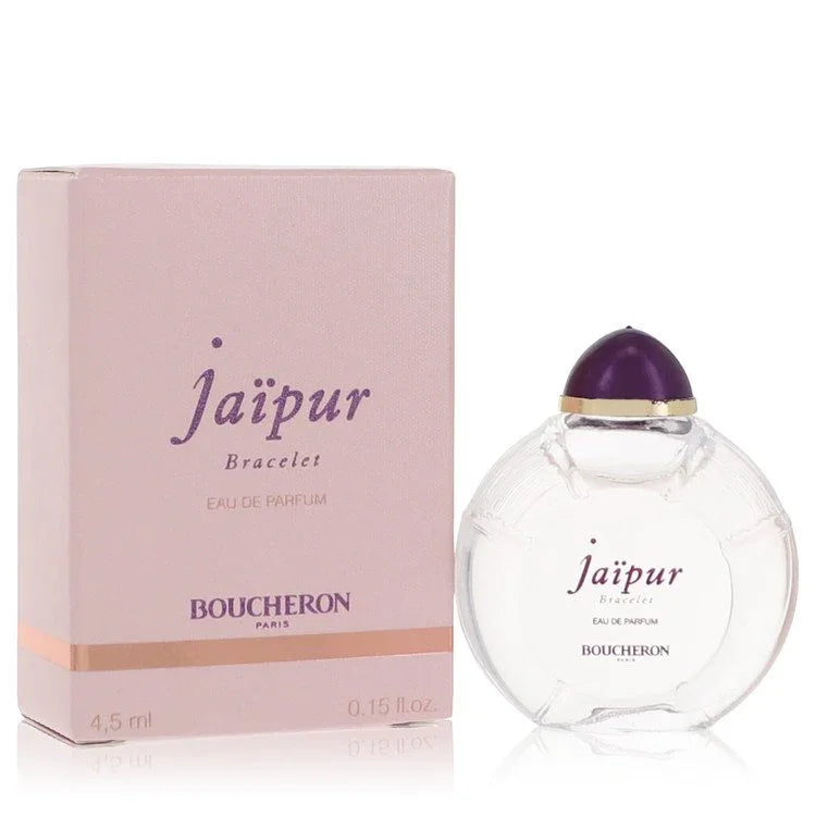 Boucheron Jaipur Bracelet Eau de Parfum signature luxury clear architectural glass column jewelry flacon showcasing its transparent fluid boundaries, styled with elegant brand markings layout, and topped with an ornate sculpted pink gemstone capping accent design detail against a solid backdrop