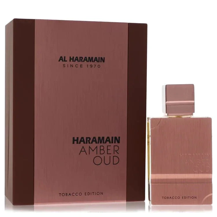 Al Haramain Amber Oud Tobacco Edition luxury cologne bottle featuring a gold and amber design — a deeply opulent oriental woody fragrance with smoky tobacco, warm spices, rose, oud, and vanilla notes