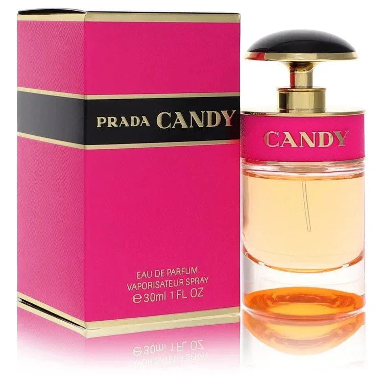 Prada Candy Eau de Parfum signature luxury clear glass cylindrical architectural flacon wrapped in a vibrant pink textured band displaying bold brand typographic text markings, capped with an elegant glossy black half-moon atomization trigger configuration detail against a solid backdrop