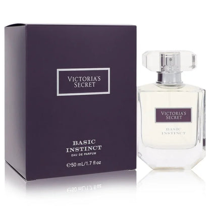 Victoria's Secret Basic Instinct Eau de Parfum 50ml bottle next to its dark purple packaging box on a white reflective background.