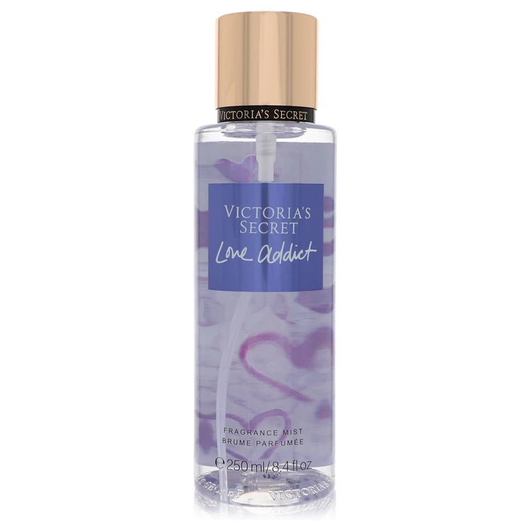 Victoria's Secret Love Addict fragrance mist bottle on a white background