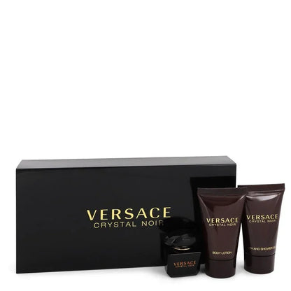 Versace Crystal Noir gift set with black box, bottles, and containers on a white background