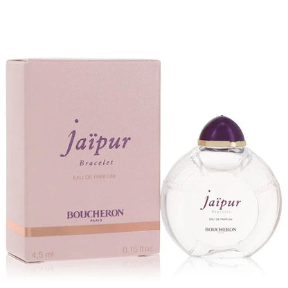 Boucheron Jaipur Bracelet Eau de Parfum signature luxury clear architectural glass column jewelry flacon showcasing its transparent fluid boundaries, styled with elegant brand markings layout, and topped with an ornate sculpted pink gemstone capping accent design detail against a solid backdrop