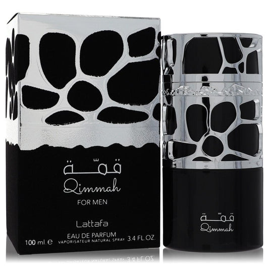 Lattafa Qimmah Cologne bottle in dark glass with metallic cage — woody spicy fragrance with bergamot, spices, woody notes, and leather.