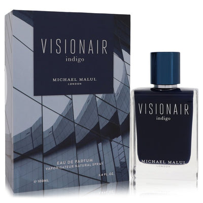Michael Malul Visionair Indigo Eau de Parfum bottle in indigo glass with metallic cap — woody aquatic fragrance with pomelo, ocean waters, and cedar.