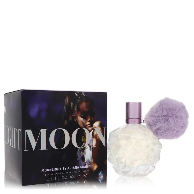 Moonlight by Ariana Grande perfume with faceted bottle, lavender cap, and fluffy pompom beside box.