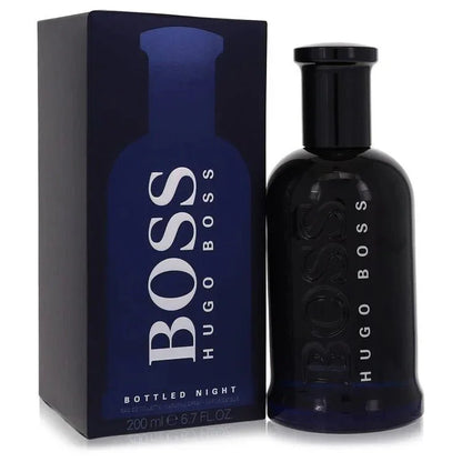Hugo Boss Boss Bottled Night Eau de Toilette signature luxury midnight blue architectural glass flacon displaying its dark translucent fluid boundaries, styled with minimalist brand typographic text, and topped with a sleek deep black cap configuration detail against a solid backdrop