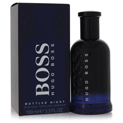 Hugo Boss Boss Bottled Night Eau de Toilette signature luxury midnight blue architectural glass flacon displaying its dark translucent fluid boundaries, styled with minimalist brand typographic text, and topped with a sleek deep black cap configuration detail against a solid backdrop