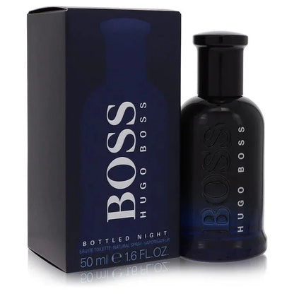 Hugo Boss Boss Bottled Night Eau de Toilette signature luxury midnight blue architectural glass flacon displaying its dark translucent fluid boundaries, styled with minimalist brand typographic text, and topped with a sleek deep black cap configuration detail against a solid backdrop
