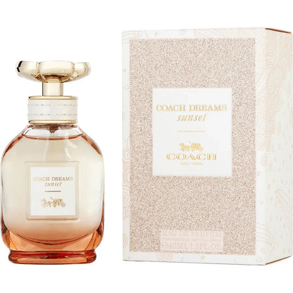 Coach Dreams Sunset Eau de Parfum bottle and box with gold and peach gradient design