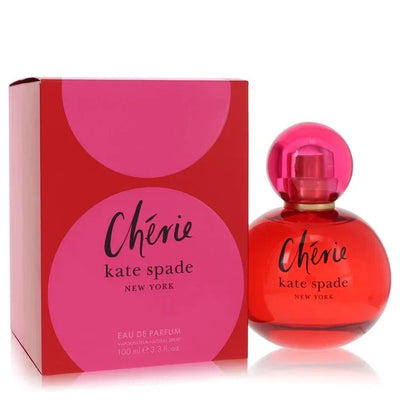 Vibrant curvy red and pink bottle of Kate Spade New York Cherie perfume for women, showcasing its modern, joyful design on a high-end display surface.