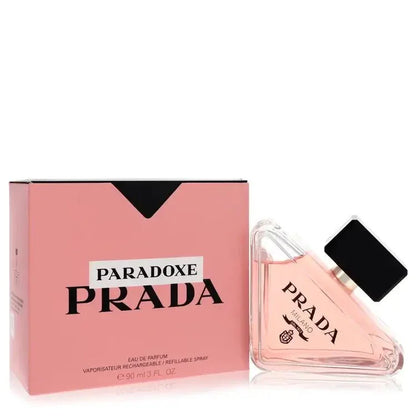 Prada Paradoxe Perfume signature luxury diamond-shaped triangular architectural glass flacon resting tilted displaying delicate pink fluid tones, styled with bold black contrast brand typographic markings, and topped with an elegant glossy black cylindrical collar closure detail against a solid backdrop